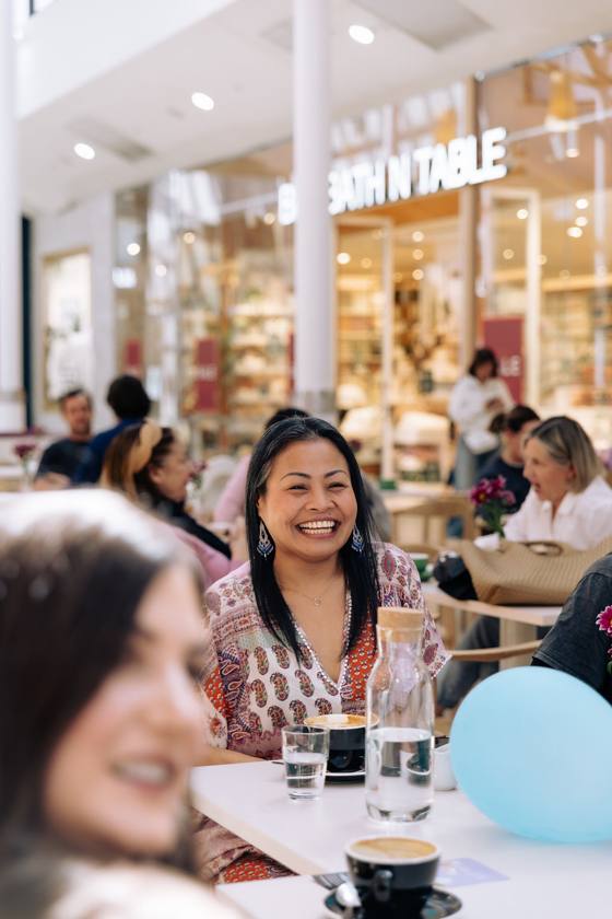 A mum in business laughing at a Wanna Grab a Coffee morning in Adelaide