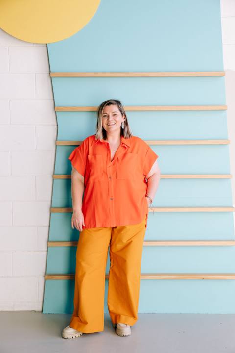 Sandra Senn, who teaches Claude for Social Media in Adelaide, smiling in front of a blue wall