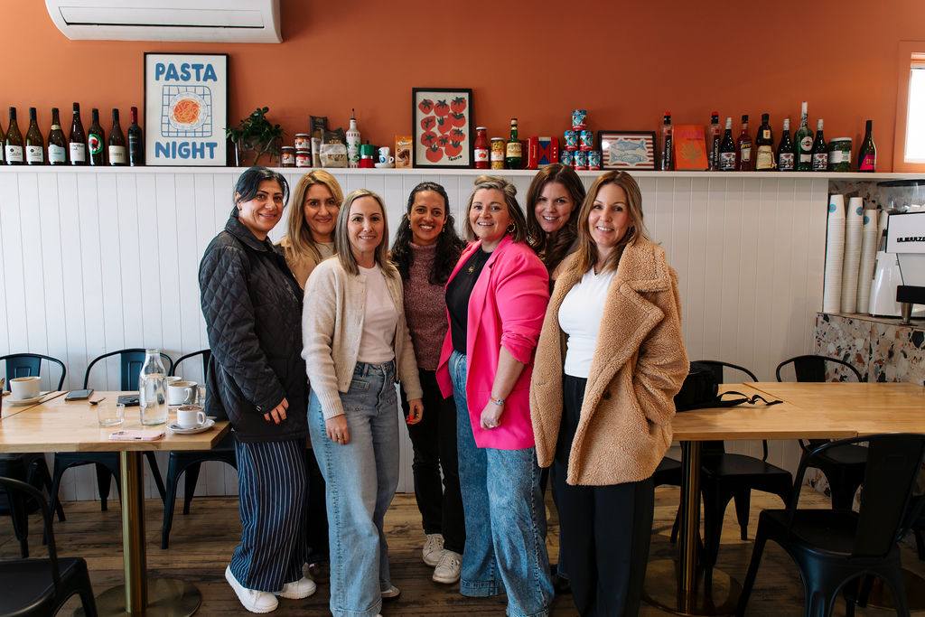 Seven Adelaide women in business together at a cafe