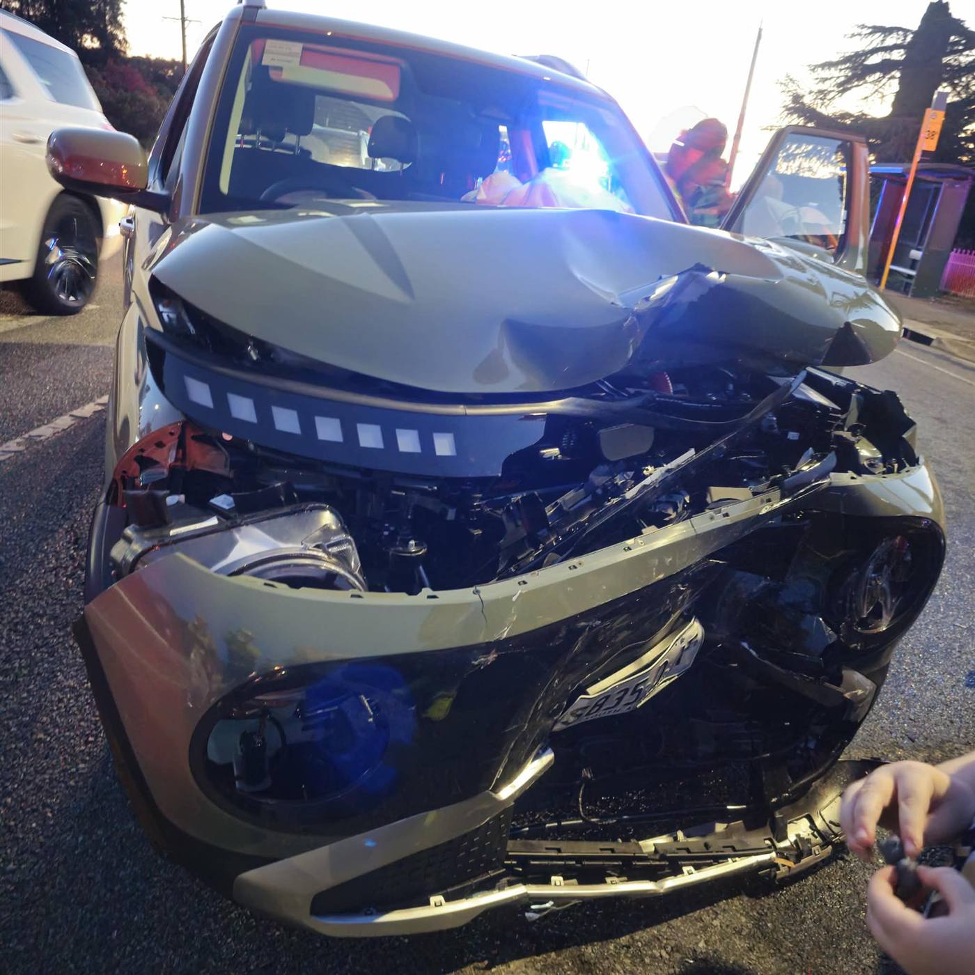 The front of Sandra's parents' car after the crash, bonnet crumpled and airbags deployed