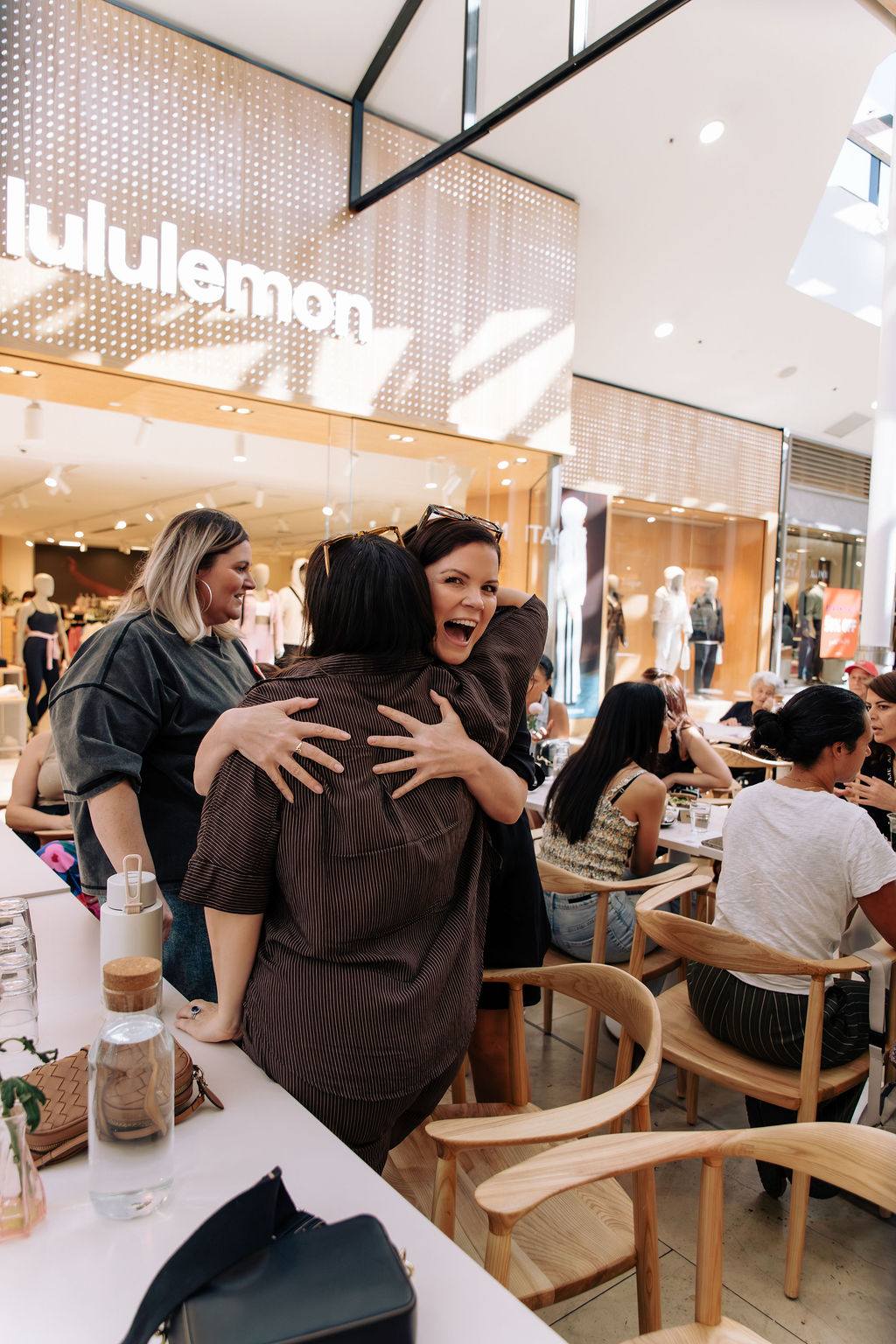 Two women hugging at a Business Mums Hub Open Coffee in Adelaide