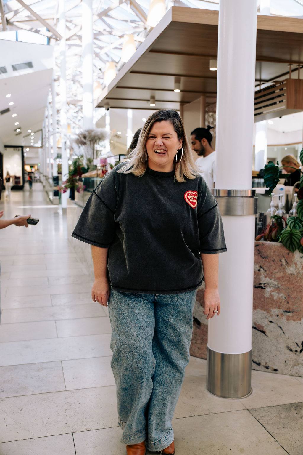 Sandra pulling a cheeky face in a shopping mall